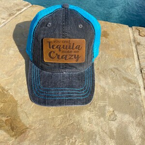 May include: A black and blue trucker hat with a brown leather patch that says "You and Tequila make me Crazy".