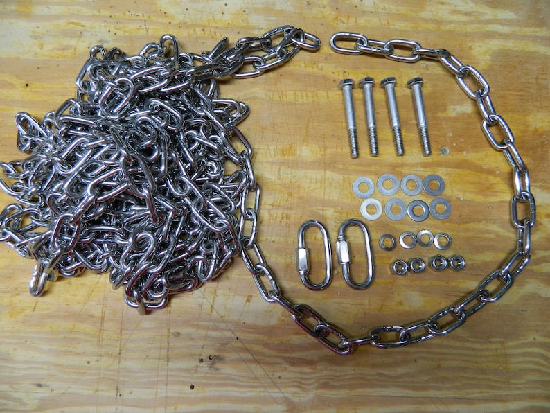 May include: A set of silver hardware for hanging a swing or other object. The set includes a chain, two hooks, four bolts, eight washers, and eight nuts.