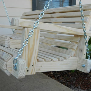 May include: A wooden swing with a slatted back and seat, hanging from two silver chains. The swing is made of unfinished wood and has a natural wood color.