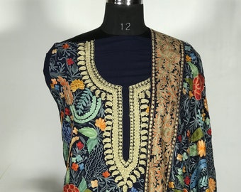 May include: A navy blue embroidered dress with a floral pattern in shades of red, orange, yellow, green, and blue. The dress has a V-neckline and a long, flowing skirt.