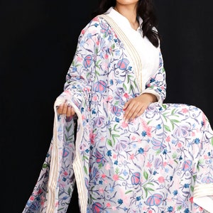 May include: White sheer shawl with a floral embroidery pattern in shades of pink, blue, and green. The shawl has a gold and white border.