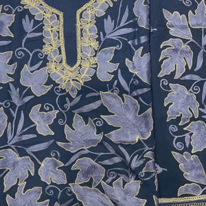 May include: A dark navy blue fabric piece featuring intricate embroidery of light purple leaves with gold-colored outlines. The design includes a U-shaped neckline bordered by gold stitching and a separate vertical panel with matching leaf patterns.