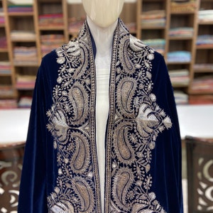 May include: A navy blue velvet shawl with silver embroidery featuring paisley and floral patterns.