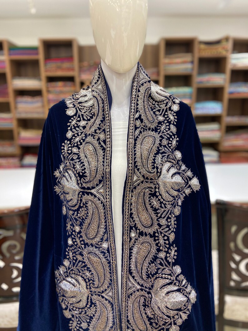 May include: A navy blue velvet shawl with silver embroidery featuring paisley and floral patterns.