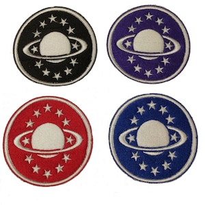 May include: Four embroidered iron-on patches featuring a white planet with rings surrounded by a circle of white stars. The patches are on a black, purple, red, and blue background.