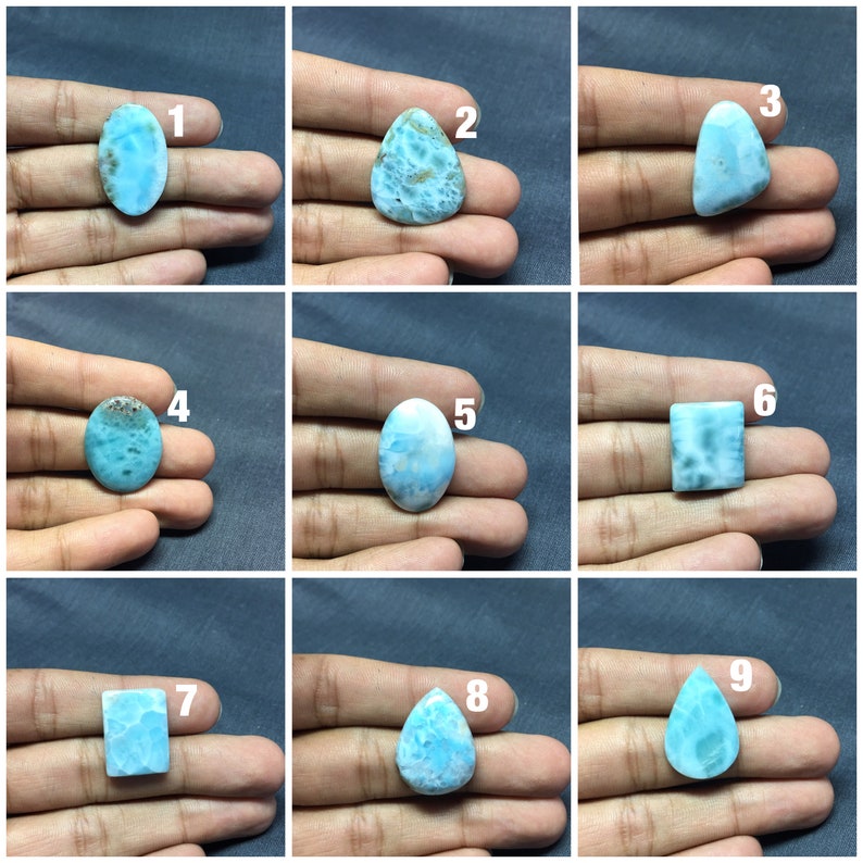 May include: Nine different cabochon gemstones, each with a unique shape and pattern. The gemstones are all a light blue color with white and gray swirls. The gemstones are numbered 1 through 9.