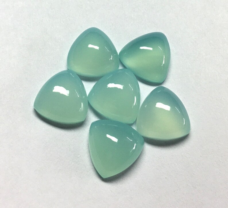 Puede incluir: Seis piedras preciosas triangulares en cabuj&oacute;n de color verde claro. Las piedras preciosas son lisas y pulidas.