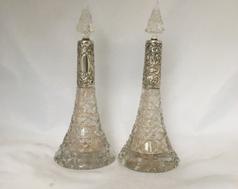 A pair of Edwardian silver mounted perfume bottles