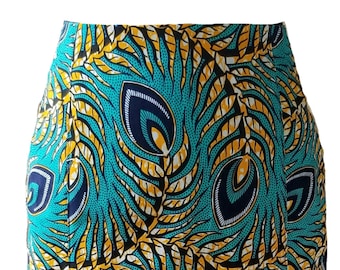 May include: A pencil skirt with a vibrant peacock feather pattern. The skirt features a teal background with yellow, navy, and white feather designs. The fabric is patterned with a repeating motif.