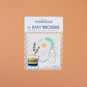 May include: A kit for easy embroidery with a white fabric panel featuring a colorful abstract design with a vase, leaves, and a sun. The kit includes embroidery floss in various colors and the text "Britney POMPADOUR Kit EASY BRODERIE Super facile, meme pour les débutants! Klin d'Oeil x POMPADOUR".