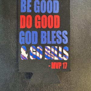May include: Black beverage insulator with the phrases "BE GOOD DO GOOD GOD BLESS & GO BILLS" in blue and red text. The text "- MVP 17" is in red. The insulator has a cutout for a can or bottle.