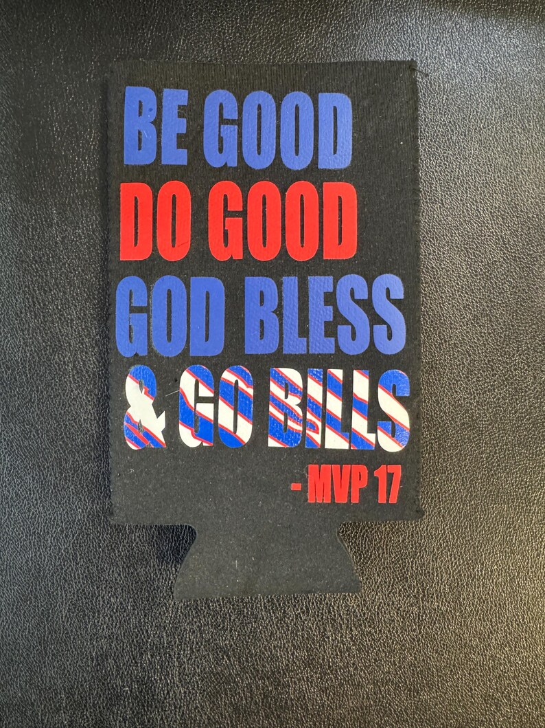 May include: Black beverage insulator with the phrases "BE GOOD DO GOOD GOD BLESS & GO BILLS" in blue and red text. The text "- MVP 17" is in red. The insulator has a cutout for a can or bottle.