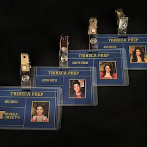 May include: Four blue and gold Tribeca Prep ID badges with photos and names, held by silver clips. Names include Alex Russo, Harper Finkle, Justin Russo, and Max Russo. The Tribeca Turkeys logo is visible on one badge.