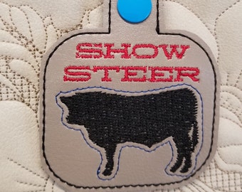 Show Steer snap tab key fob in the hoop embroidery pattern. In the hoop keychain template. 4H farm design.