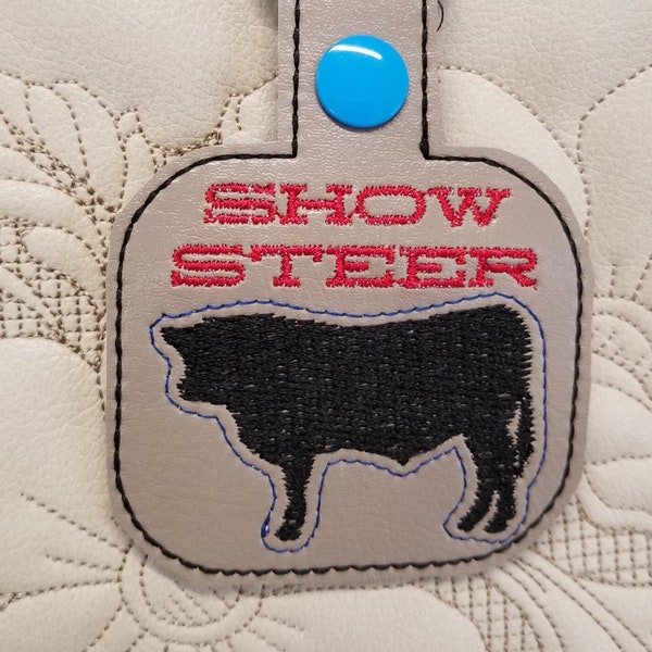 Show Steer snap tab key fob in the hoop embroidery pattern. In the hoop keychain template. 4H farm design.