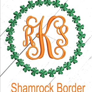 May include: A monogram letter "K" in orange embroidery with a green shamrock border. The text "Shamrock Border" is below the monogram.