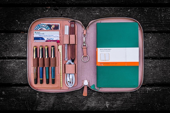 A handcrafted natural leather folio that holds both an iPad Mini AND a Moleskine in one elegant package — 71 favorites confirm this scratches a real itch for analog-digital creatives.