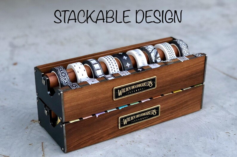 May include: A wooden organizer for storing washi tape. The organizer is made of dark wood and has a black metal frame. It is labeled "Walden Woodworkers" and features a stackable design.