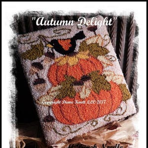 May include: A punch needle pattern featuring a pumpkin with a bird perched on top. The pattern is surrounded by leaves and vines. The text "Autumn Delight" and "Copyright Diane Knott LLC 2017" is visible.