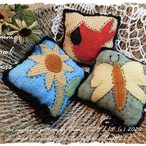 May include: Three felt applique pillow ornaments, a sunflower, a cardinal, and a butterfly, in a woven basket. "Summer Bowl Fillers" is written on the image. An applique pattern by Diane Knott LLC (c) 2020. Sold by www.etsy.com/shop/Diane Knott LLC