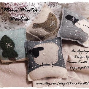 May include: Four small felt ornaments with applique designs. The ornaments are a snowman, a bird, a tree, and a sheep. The ornaments are all white with gray accents. The text "Mini Winter Woolies" is at the top of the image. The text "An Applique Design by Diane Knott LLC Copyright 2017" is at the bottom of the image.