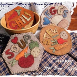 May include: Five felt hot pot holders with applique designs. The designs are "Soup", "Chili", "Stew", "Veggies", and "Eggs". The pot holders are on a plaid fabric background.