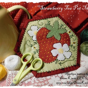 May include: A red, green, and white quilted tea pot mat with a strawberry design. The mat is shaped like a hexagon and has a stitched border. The text "Strawberry Tea Pot Mat" is written at the top of the image.