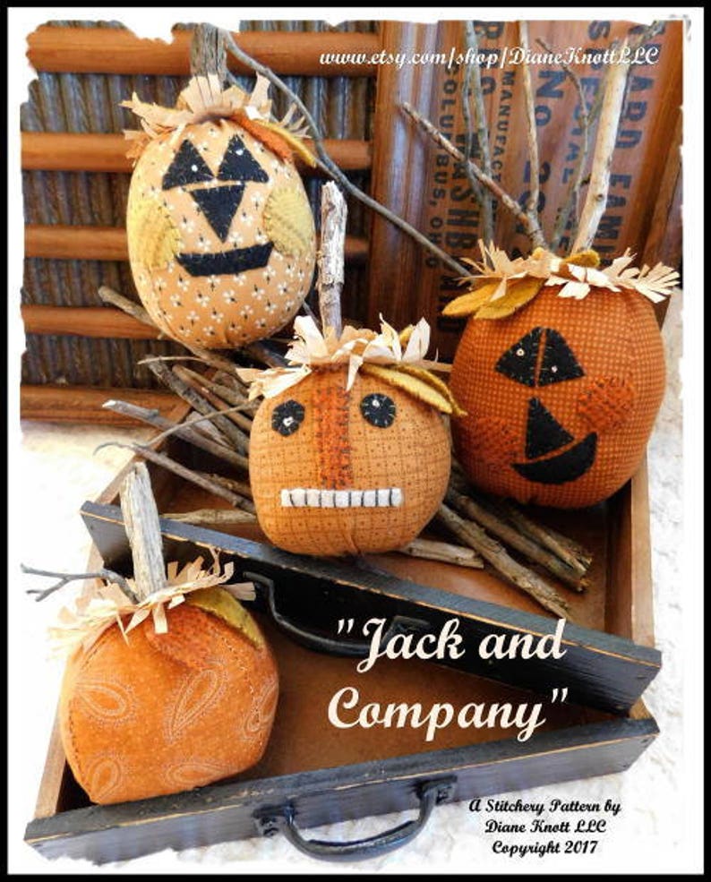 May include: Four handmade fabric pumpkins with stitched faces, in shades of orange and brown, arranged on a wooden tray with the text "Jack and Company" and "A Stitchery Pattern by Diane Knott LLC Copyright 2017".