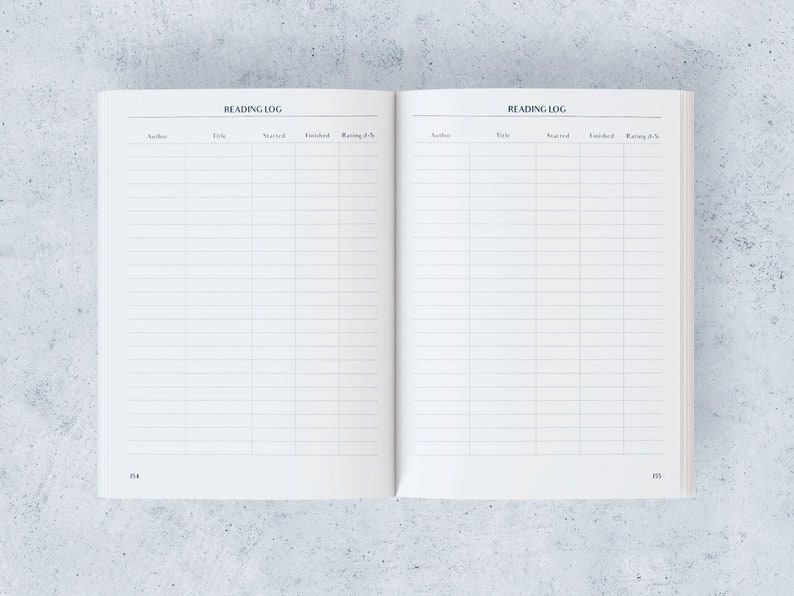 May include: Open reading log notebook with lined pages. The title "READING LOG" is printed at the top of each page. Columns are labelled for author, title, start date, finish date, and rating.