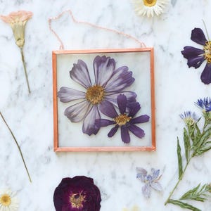 May include: A set of three ceramic mugs with a speckled, matte finish. The mugs are in shades of cream, light gray, and dark gray. Each mug has a simple, minimalist design and a rounded handle.