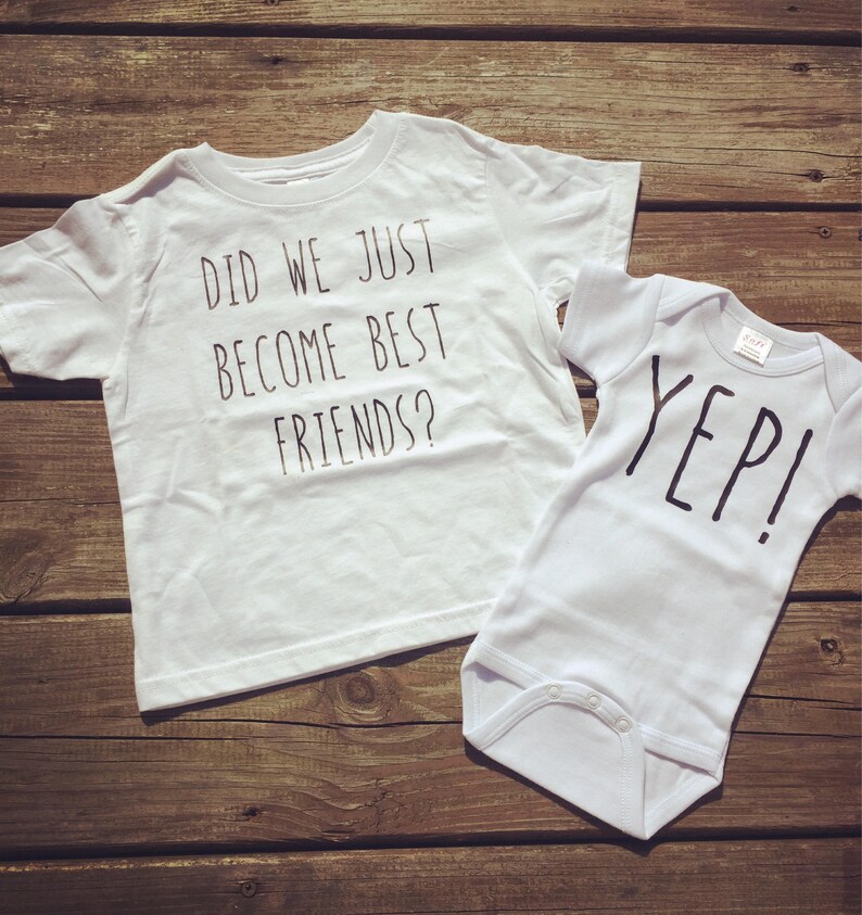 May include: Two white shirts with black text. The larger shirt says "Did we just become best friends?" and the smaller shirt says "Yep!"