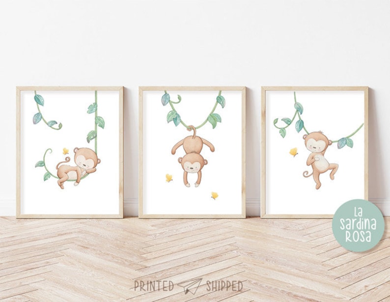 May include: Three framed prints featuring watercolor illustrations of monkeys swinging on vines. Each print has a different monkey pose and is set against a white background with green vines.