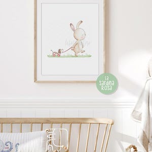 May include: A watercolor illustration of a brown bunny rabbit walking with a small dog on a leash. The bunny is wearing a pink collar and the dog is wearing a red collar. The background is a light green color. The text "La sardina rosa" is written in the bottom right corner of the image.
