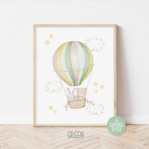 May include: A watercolor illustration of a hot air balloon with a bear and two bunnies inside. The balloon is green, yellow, and pink with white stripes. The background is white with yellow stars and white clouds.