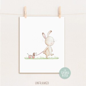 May include: A watercolor illustration of a brown bunny rabbit walking a brown and white puppy on a pink leash. The bunny is wearing a pink collar and the puppy is wearing a red collar. The background is a light green.