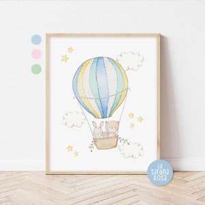 May include: A watercolor illustration of a hot air balloon with a bear and two bunnies inside. The balloon is blue, yellow, and green with white stripes. The background is white with clouds and stars.