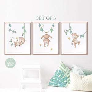 May include: Set of three watercolor prints featuring monkeys swinging on vines. The monkeys are brown with light brown faces and are depicted against a white background with green vines.
