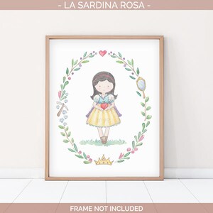 May include: A watercolor illustration of Snow White, a Disney princess, holding a red apple. She is surrounded by a wreath of green leaves and flowers. The illustration is framed in a light brown frame.