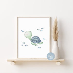 May include: A watercolor illustration of a green sea turtle swimming with blue fish. The turtle has a blue shell and is surrounded by small blue fish. The illustration is on a white background.