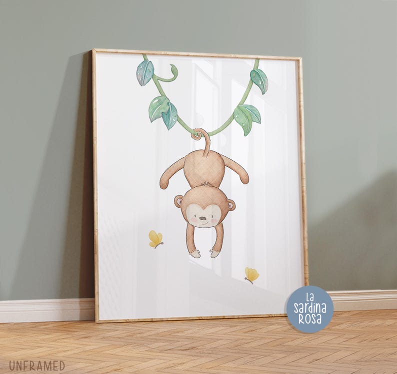 May include: A watercolor illustration of a monkey hanging from a vine with green leaves. The monkey is brown and has a cute face. There are yellow butterflies on the white background. The image is framed and has the text "La Sardina Rosa" in the bottom right corner.