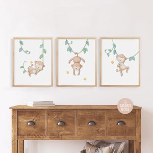 May include: Three framed prints of monkeys swinging on vines. Each print features a different monkey pose and is set against a white background with green vines.