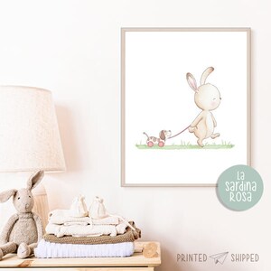 May include: A watercolor illustration of a brown bunny rabbit walking with a brown and white puppy on a leash. The puppy is pulling a red toy wagon. The illustration is on a white background with a light green grass.