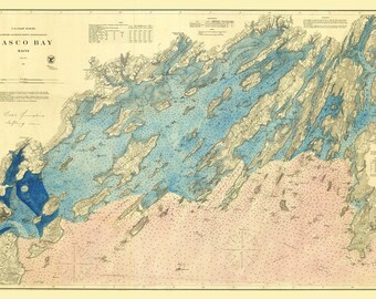 May include: A vintage nautical chart of Casco Bay, Maine, with detailed depictions of the coastline and sea floor. The map features blue, pink, and beige hues, with text indicating depths and other navigational information. The title "Casco Bay Maine" is visible.