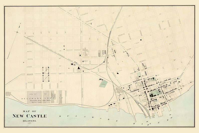 May include: A vintage map of New Castle, Delaware, showing the city's streets and buildings. The map is printed in black and white on a cream-colored background. The Delaware River is shown in blue.