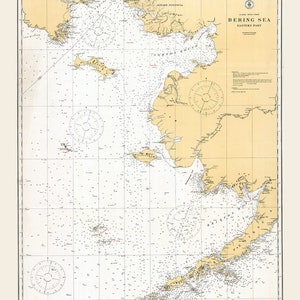 May include: A vintage nautical chart of the eastern part of the Bering Sea. The chart is printed on cream-coloured paper with brown and red lines and text. The chart includes compass roses, depth soundings, and navigational information.