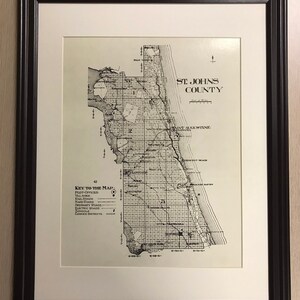 May include: A black and white map of St. Johns County, Florida. The map shows the location of post offices, villages, railroads, hard roads, ordinary roads, electric roads, schools, and commissioner districts. The map is labeled "St. Johns County" and "St. Augustine".