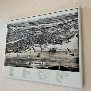 May include: A black and white vintage map of St. Augustine, Florida, showing the city's layout and surrounding areas. The map includes a key with numbered locations and their corresponding names.
