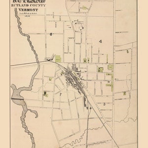 May include: An antique map of Rutland, Vermont, from 1876. The map shows the layout of the city with streets, buildings, and a river. The map is printed in black and white on a cream-colored background.