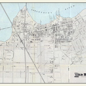 May include: A vintage map of Red Bank, New Jersey, showing the streets and buildings of the town. The map is printed in black and white on a light blue background. The map includes the text "Red Bank" in a decorative font.