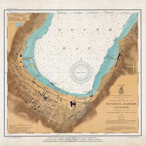 May include: A vintage nautical chart of Munising Harbor on Lake Superior, Michigan. The chart is dated July 12, 1907, and shows the harbor's depth, shoreline, and surrounding land features. The chart is printed in black and white with blue and green accents.